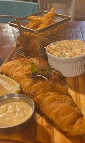 a plate of food with fish and chips and dip at Lanseria Country Estate in Lanseria