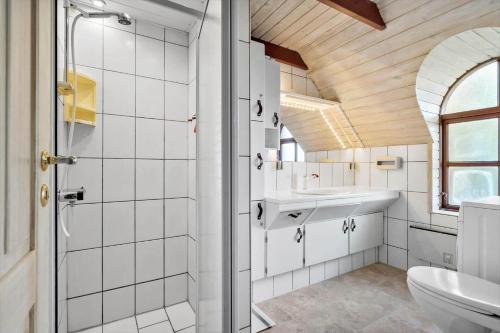 a bathroom with a shower and a sink and a toilet at 378-Hvide-Sande-Sivbjerg-9 in Hvide Sande