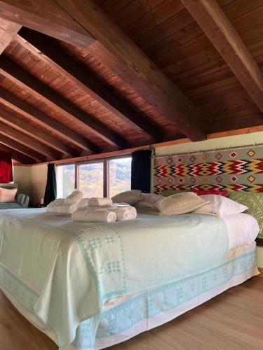 a bedroom with a large bed in a room at Casa Ziranu Sa Domo e su Cantaru in Orani