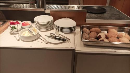 a kitchen counter with plates and a tray of food at Gasthaus Hotel Sonne in Villingen-Schwenningen