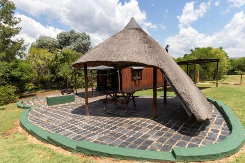 a small gazebo with a table and a table at Nullarbor Cottages in Magaliesburg