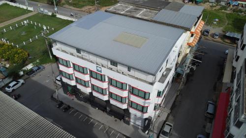 an overhead view of a white building with a blue roof at V1 boutique hotel in Kanchanaburi