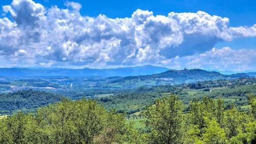 a view of a valley with trees and clouds at Villa Amorosa - Monte Castello di Vibio in Monte Castello di Vibio