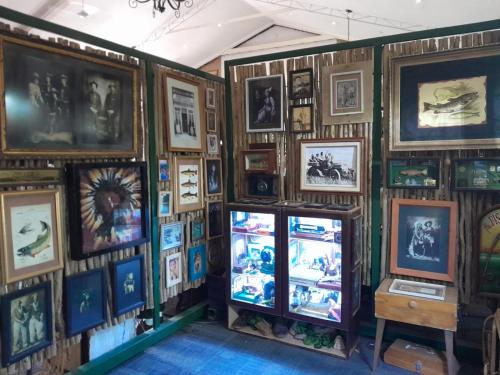 a room with a wall of pictures and a tv at Lanseria Country Estate in Lanseria