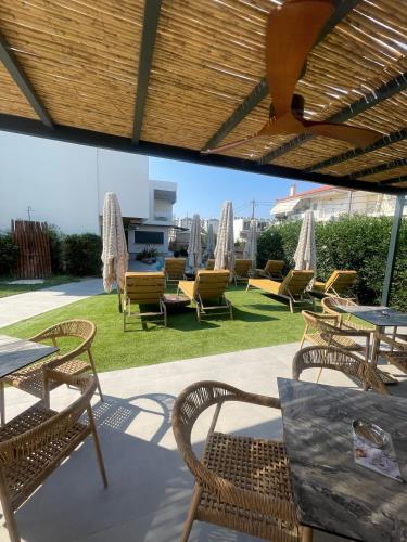 a group of chairs and tables on a patio at Olvion Luxury Living in Kallithea Halkidikis