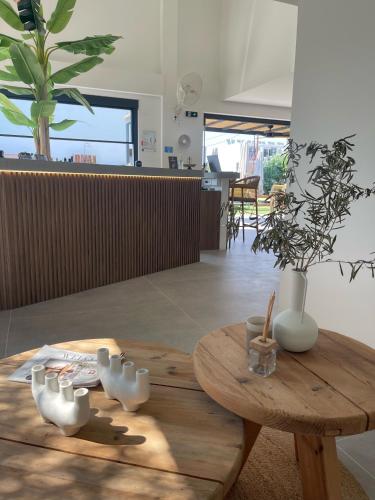 a wooden table with white vases on top of it at Olvion Luxury Living in Kallithea Halkidikis