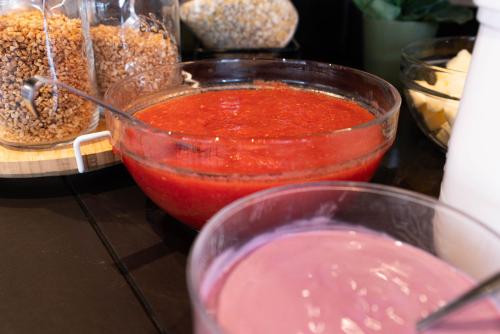 a table topped with bowls of sauce and other foods at Ibis Malaga Centro Ciudad in Málaga
