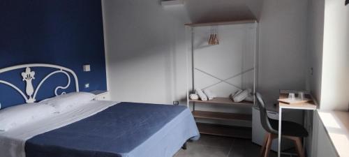 a blue bedroom with a bed and a chair at Contrada Cafaro in Salerno