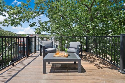 a patio with two chairs and a table on a deck at 3BR3Bth Penthouse 2 Parking Spaces TD MIT Harvard in Somerville