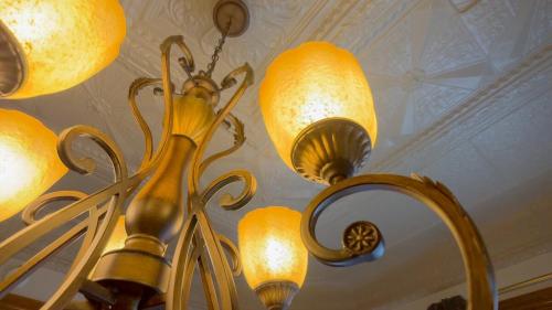 a chandelier hanging from a ceiling with lights at Court St Suite in Clarksburg