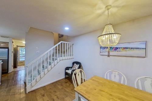 a dining room with a table and a chandelier at Salt Pond --- 38435 Mainsail Dr #9 in Bethany Beach