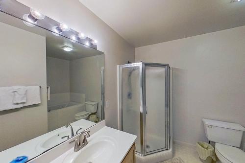 a bathroom with a shower and a sink and a toilet at Salt Pond --- 38435 Mainsail Dr #9 in Bethany Beach