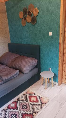 a living room with a couch and a table at Domek Zielenina in Mierzeszyn