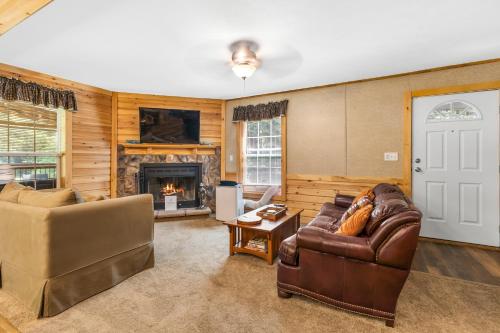 a living room with a couch and a fireplace at Schroon River Bend Getaway in Schroon Lake