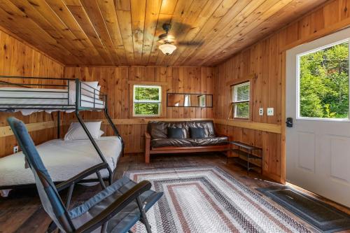 a room with a bunk bed and a couch at Schroon River Bend Getaway in Schroon Lake