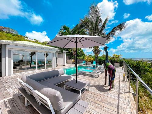 a giraffe standing on the deck of a house at Villa SEA VIEW, 5 min from the beach, overlooking the caribbean sea, private pool in Friar's Bay