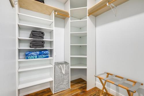 a walk in closet with white shelves at Private Pool and Backyard Villa in North Palm Beach in North Palm Beach