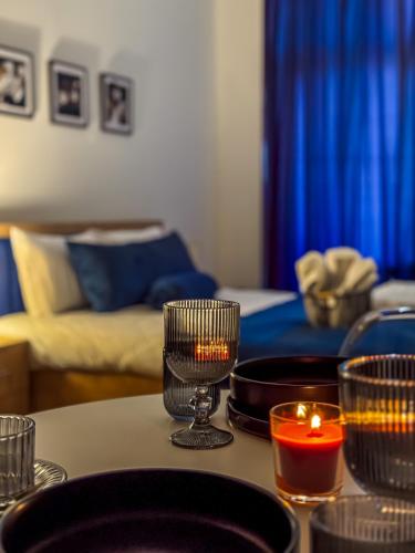 a living room with a table with candles on it at Monroe Chic Studio in Tbilisi City