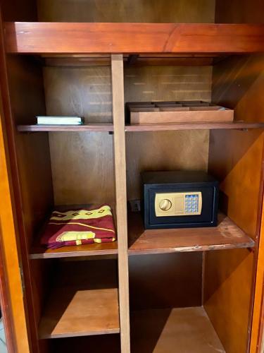 a wooden book shelf with a radio in it at Elite Park Hotel in Jeddah