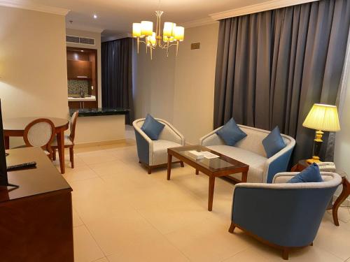 a living room with a couch and chairs and a table at Elite Park Hotel in Jeddah