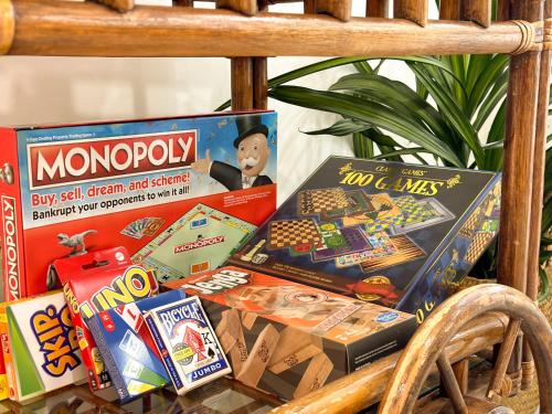 a pile of toys and games on a table at colorfully designed 4 bedroom home with pool in Pompano Beach