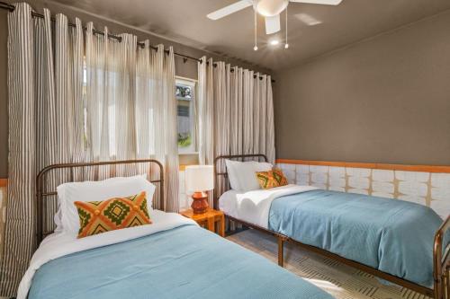 a bedroom with two beds and a window at colorfully designed 4 bedroom home with pool in Pompano Beach