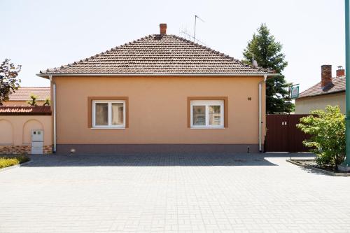a house with a driveway in front of it at Lak6 Apartment in Mórahalom
