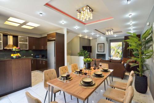 a dining room and kitchen with a table and chairs at Arieldine Luxury Apartment in Chania Town