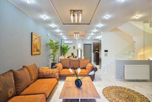 a living room with a couch and a table at Arieldine Luxury Apartment in Chania Town