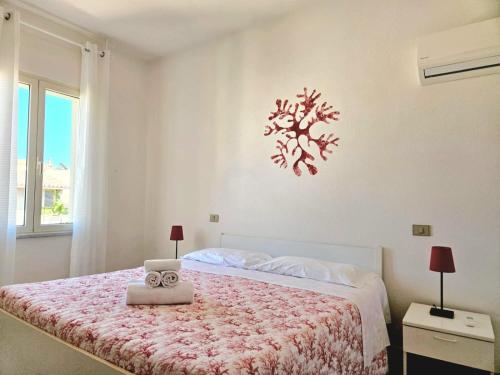 a bedroom with a bed with a clock on the wall at Bentos - Appartamenti in centro a Orosei in Orosei
