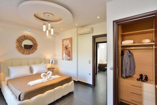a bedroom with a bed and a walk in closet at Arieldine Luxury Apartment in Chania Town