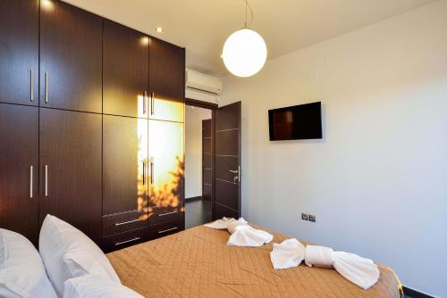 a bedroom with a bed with two towels on it at Arieldine Luxury Apartment in Chania Town