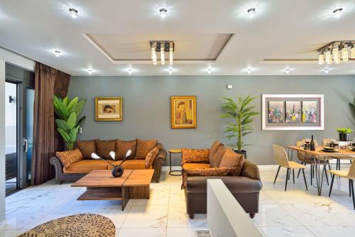 a living room with couches and a table at Arieldine Luxury Apartment in Chania Town