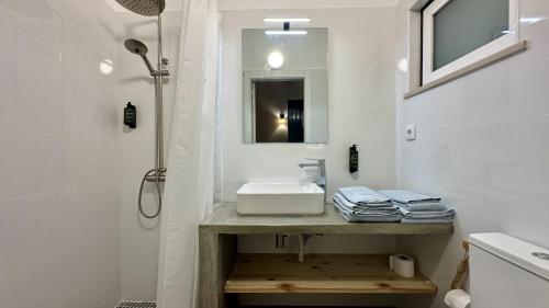 a white bathroom with a sink and a shower at Casa do Monte by Check-in Portugal in Albufeira