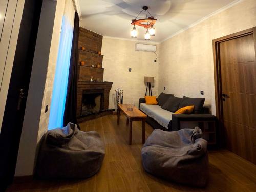 a living room with a couch and a fireplace at Guest house "Soulmate" in Ambrolauri
