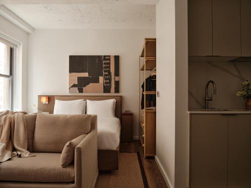 a living room with a couch and a bed at Mint House Washington DC - Downtown in Washington
