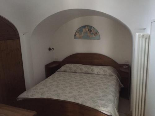 a small bedroom with a bed in a room at Il Trullo Di Santanna in Locorotondo