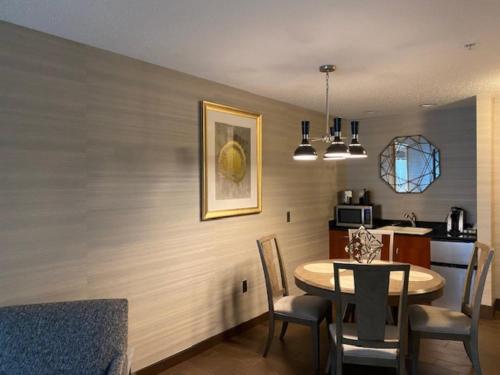 a kitchen and dining room with a table and chairs at Holiday Inn Purdue - Fort Wayne by IHG in Fort Wayne