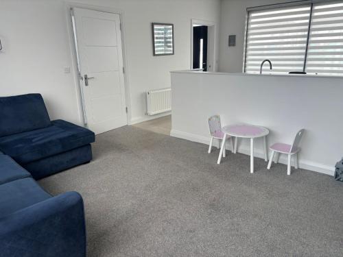 a living room with a couch and a table and chairs at The Nineteenth at Portstewart in Portstewart