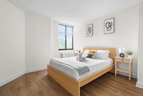 a white bedroom with a large bed and a window at Pentagon City Escape - Contemporary & Comfy in Arlington