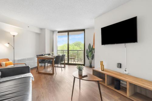 a living room with a couch and a tv on a wall at Pentagon City Escape - Contemporary & Comfy in Arlington