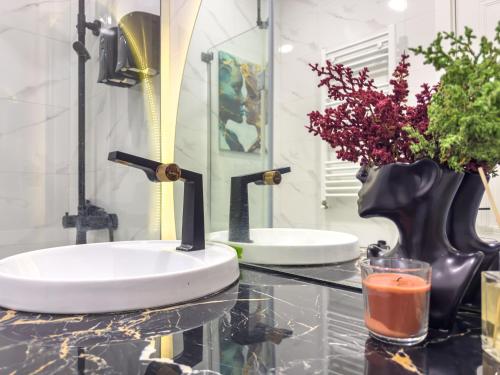 a bathroom with two sinks on a glass table at Monroe Chic Studio in Tbilisi City