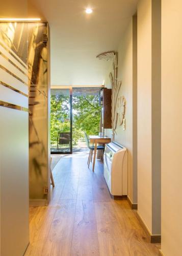 a living room with a table and a refrigerator at Nature Escape with Pool & BBQ in Viana do Castelo
