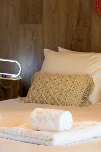 a towel sitting on top of a bed at Nature Escape with Pool & BBQ in Viana do Castelo