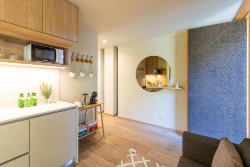 a kitchen and living room with a table and a counter at Nature Escape with Pool & BBQ in Viana do Castelo