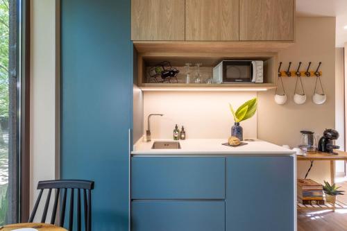 a kitchen with blue cabinets and a sink at Nature Escape with Pool & BBQ in Viana do Castelo