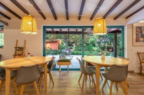 a dining room with two tables and chairs at Nature Escape with Pool & BBQ in Viana do Castelo