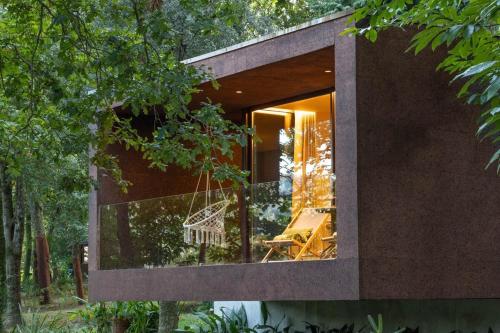 a house with a large window on the side of it at Nature Escape with Pool & BBQ in Viana do Castelo