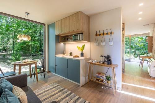 a living room with a kitchen and a dining room at Nature Escape with Pool & BBQ in Viana do Castelo