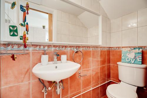 a bathroom with a sink and a toilet at Felicity - Geography of Sea - Villa with Private Pool near Kapparis Beach, Protaras in Paralimni